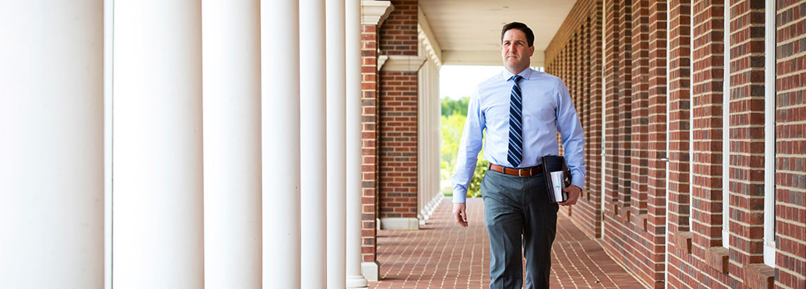 Student Walks Among Columns