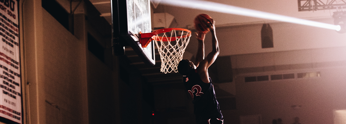 Student dunking basketball