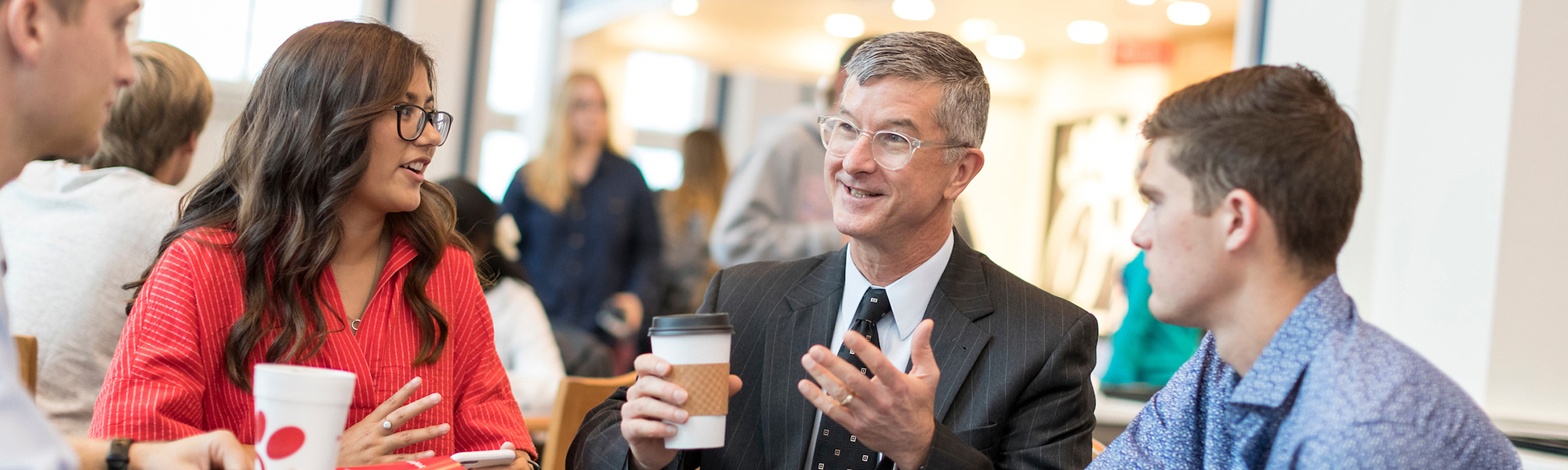 a professor talks with students at Chik-fil-a