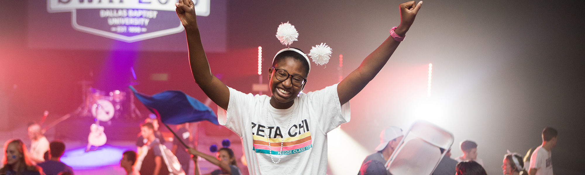 girl cheers and smiles at a student event