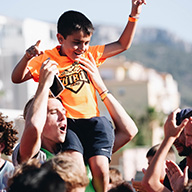 A student carries a kid on his shoulders