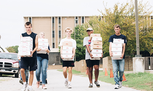 Students carrying boxes