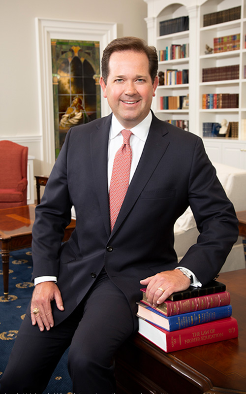 President Dr. Adam Wright sitting in his office