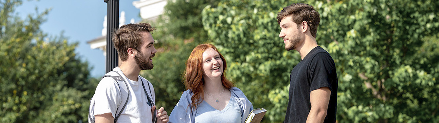 students talking outside on DBU's beautiful campus