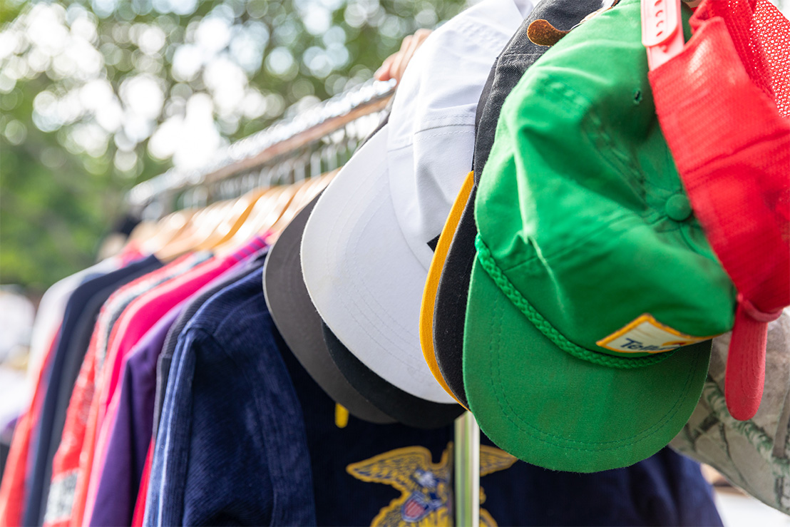 sweaters and hats on a hanger