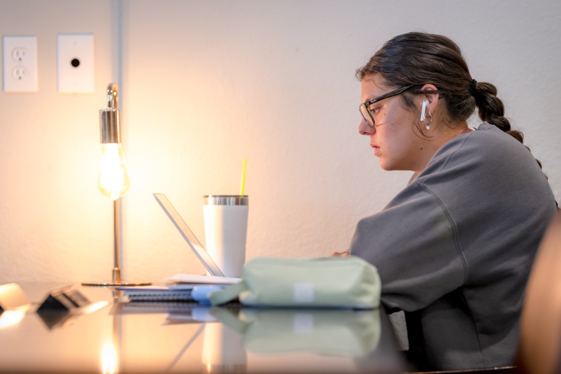 college student trying to study at a table in Dallas, Texas