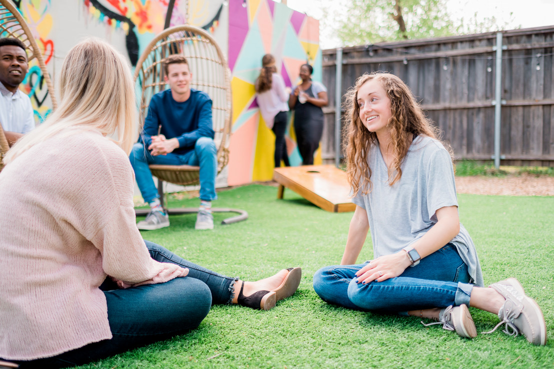 DBU College students talking outside with each other in the Bishop Arts District of Dallas, Texas