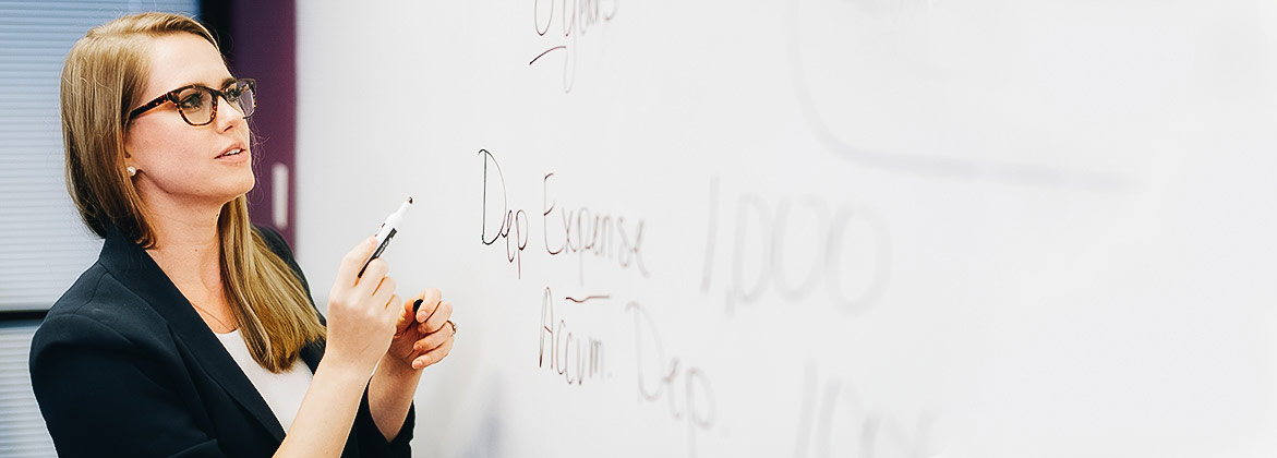 accounting faculty member in discussion with class in Dallas