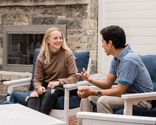 students sitting and talking outside