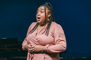 student singing on a stage