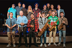 A group of people holding saxophones in their hands