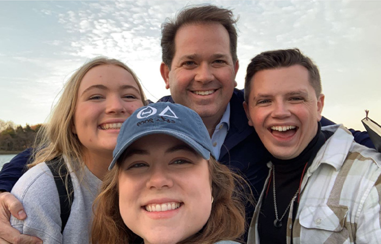 Dr. Wright poses with three students