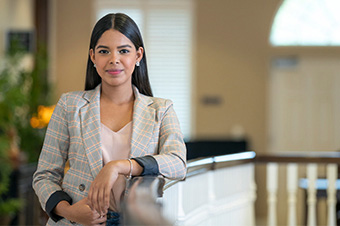 graduate student standing inside a building