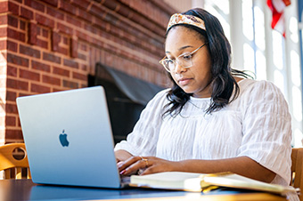 graduate student working on her classes with her laptop