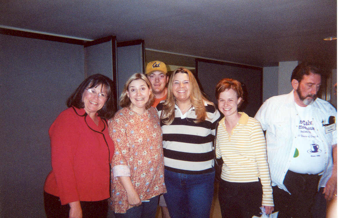 picture of a group of women and a man standing together smiling