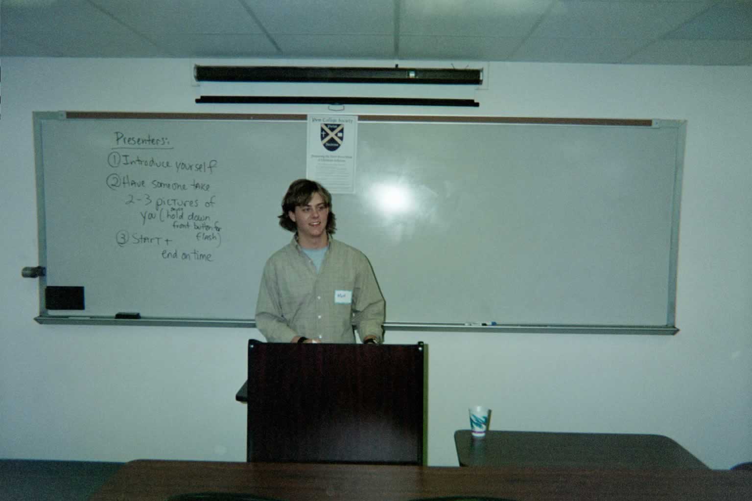 picture of a man standing behind a podium