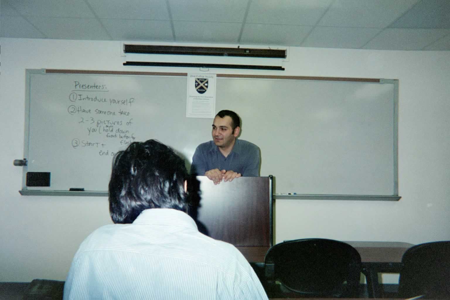 picture of a man standing behind a podium speaking