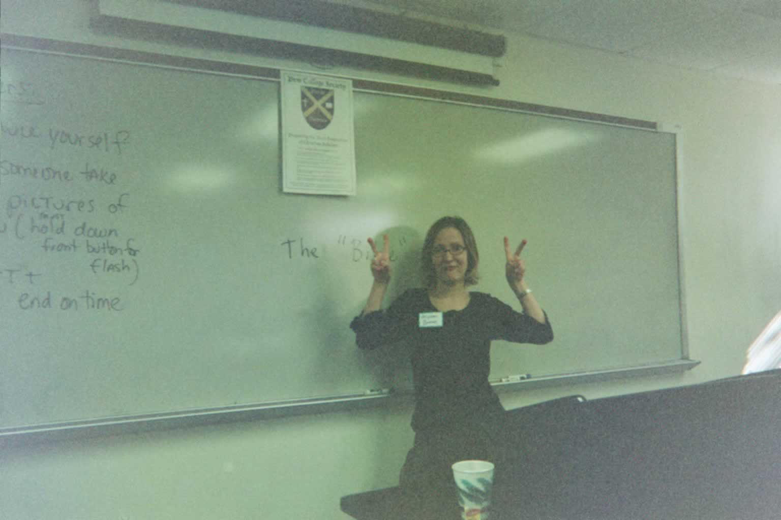 picture of a woman posing in front of a whiteboard