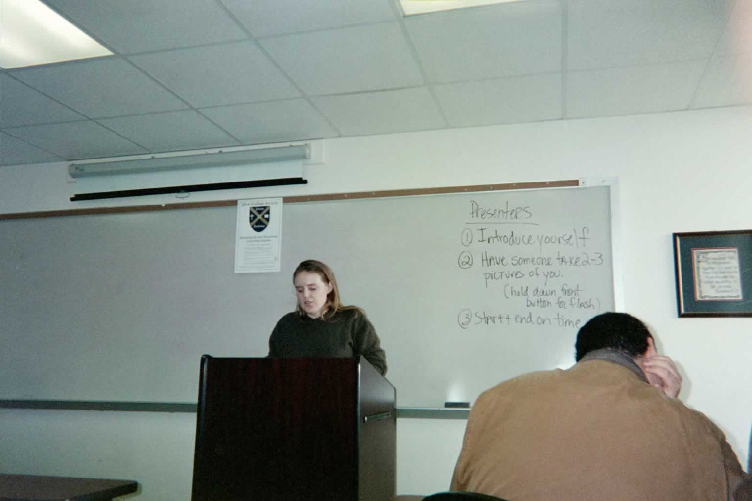 picture of woman standing behind a podium speaking