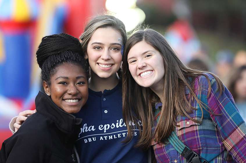 Current DBU students Elon Bohanan, Caroline Walker, & Hannah Baker enjoy the Tailgate Party before the big game