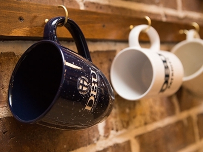 coffee mugs line the new wall of the coffeehouse