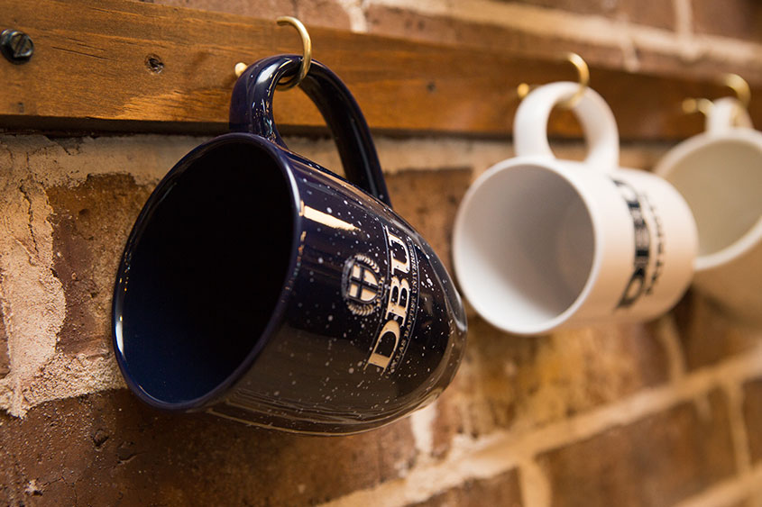 coffee mugs line the new wall of the coffeehouse