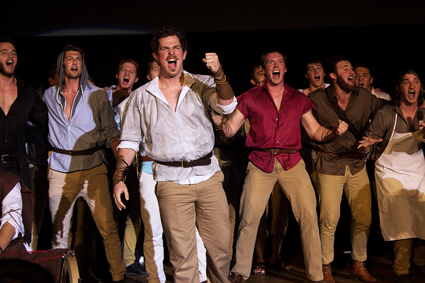 A fraternity performs in front of the crowd