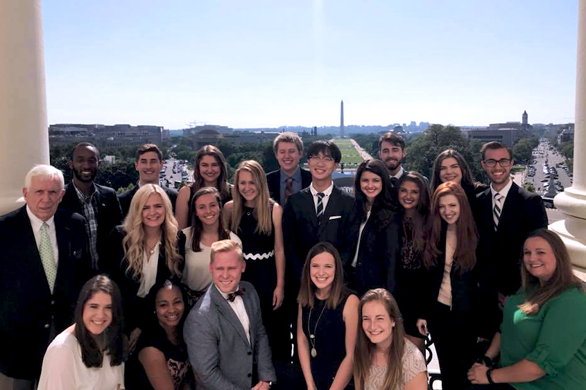 Students pose in front of the Washington Monument