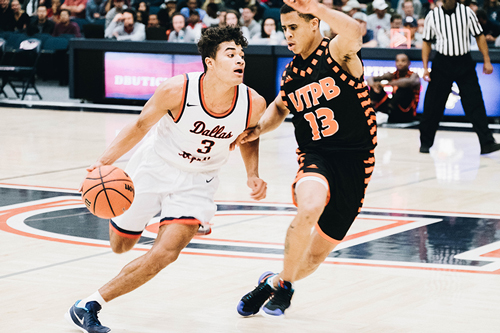 A basketball play (number 3) dribbling around another player (number 13)