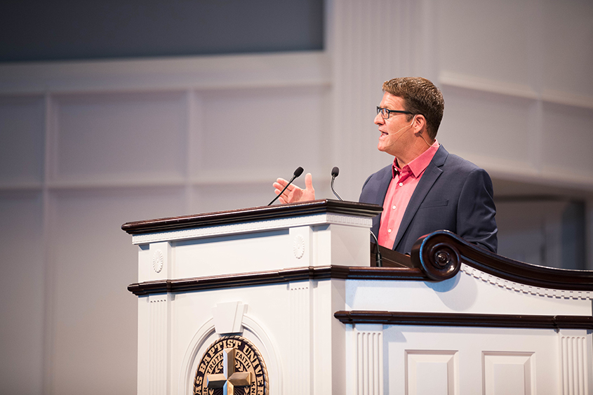 Mike Taylor, Executive Director of UK-USA Ministries, addresses students in the conference