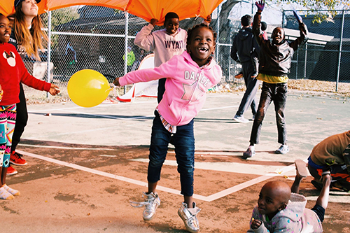 A young girl playing with a balloon. 