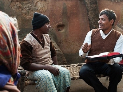 Three people reading the Bible