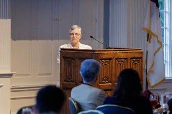 picture of Dr. Kavli speaking behind a podium