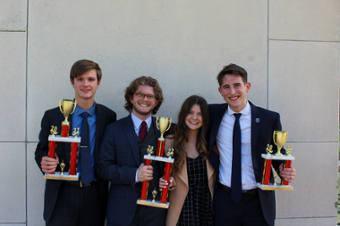 Debate Team holding trophies 