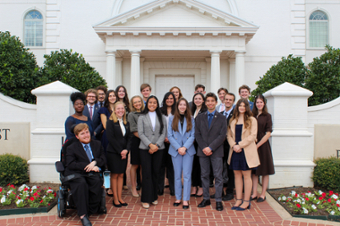 picture of the DBU Debate team standing in front of the chapel