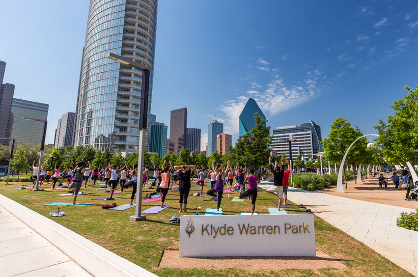 people stretching at Klyde Warren Park in Dallas