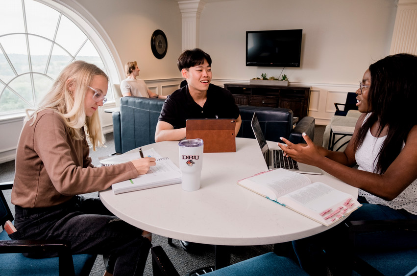 college students in Dallas, Texas sitting around a round table talking and studying