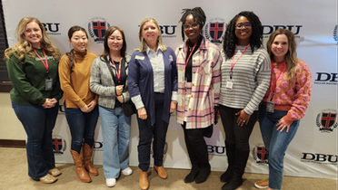 group of students standing together with Dr. Wicker