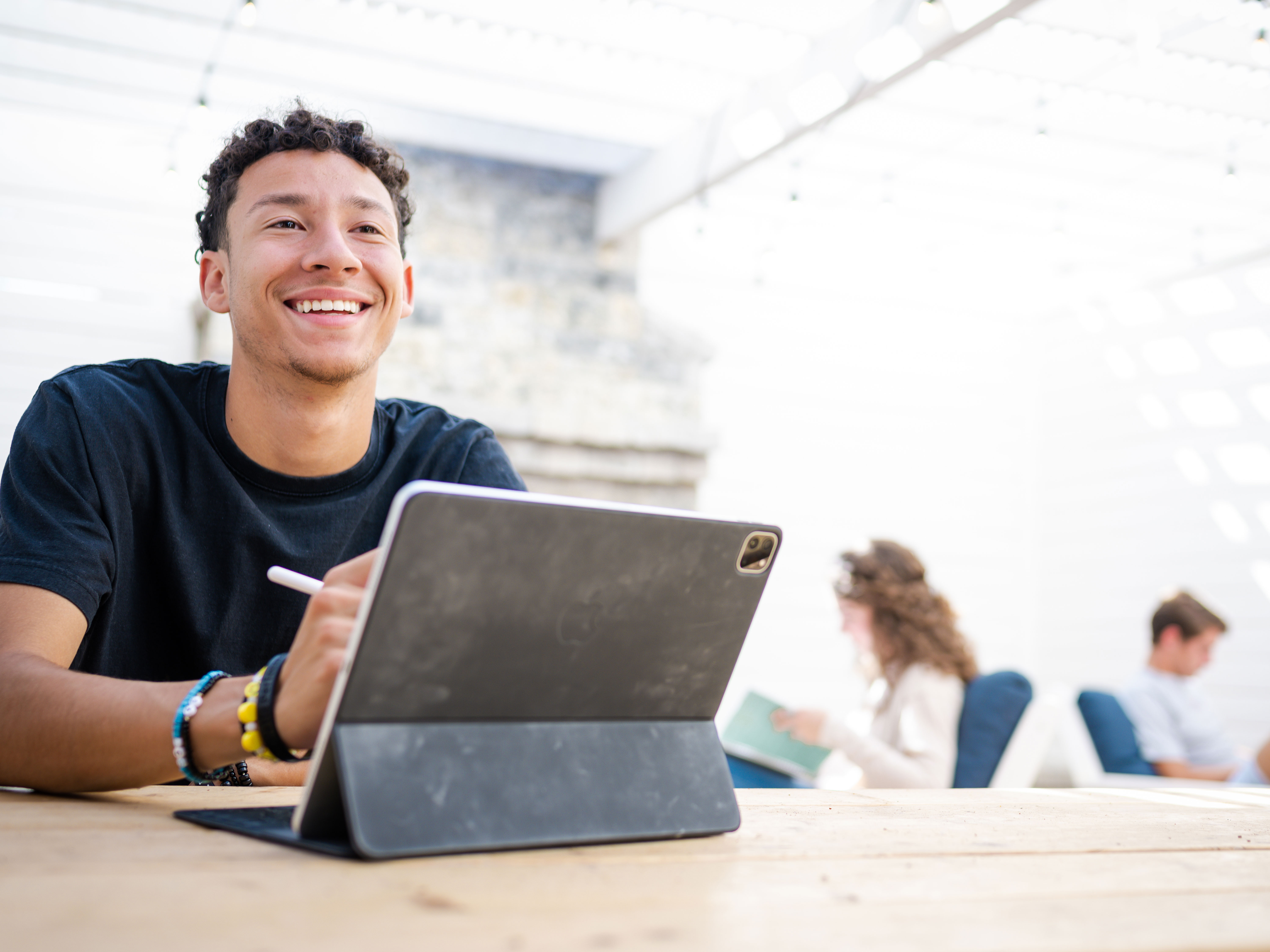 Dallas college student sitting outside with iPad