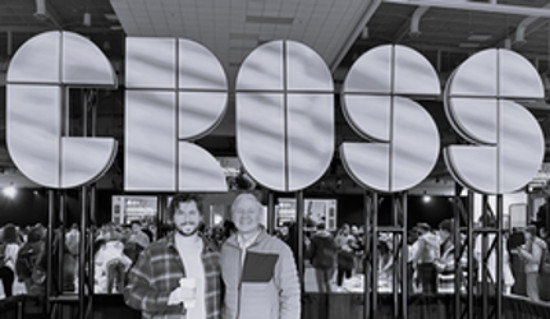 Dr. Alexander and Glen Jones standing in front of the Cross Con sign