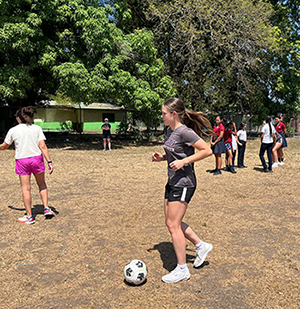 DBU student athlete playing with soccer ball