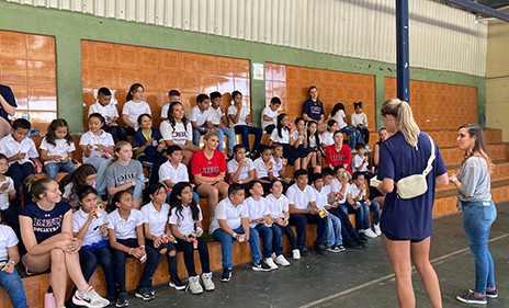 DBU student athlete speaking to a group of children