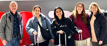 group of people at the airport with suitcases