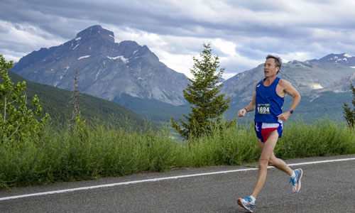 Mitch running half marathon with mountains in the background