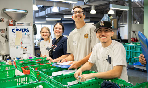 students smiling at a service project