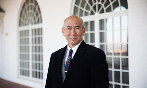 Russell standing in front of DBU building