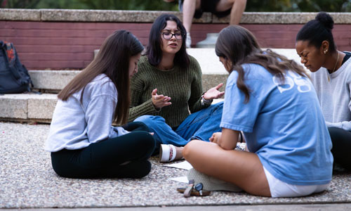 students praying in a group