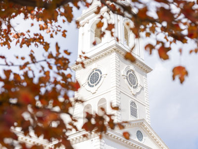 fall leaves in front of chapel steeple