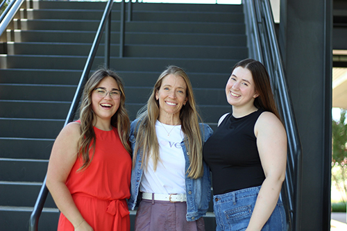 Brighter Magazine - Helen Bowles standing outside with her staff in front of stairs