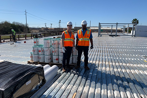 John Austin Earles standing outside on top of a building - Photo Credit Noble Roofing